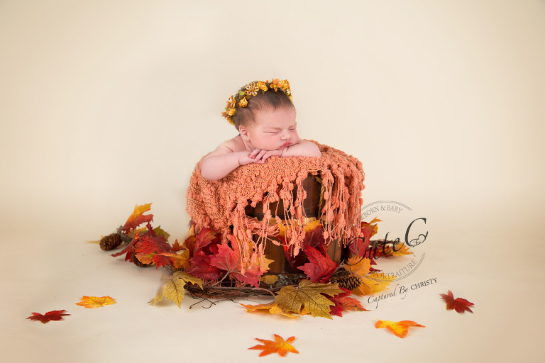 baby in the fall leaves