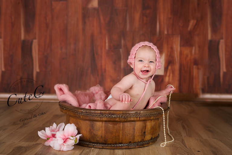 baby girl in pink bucket