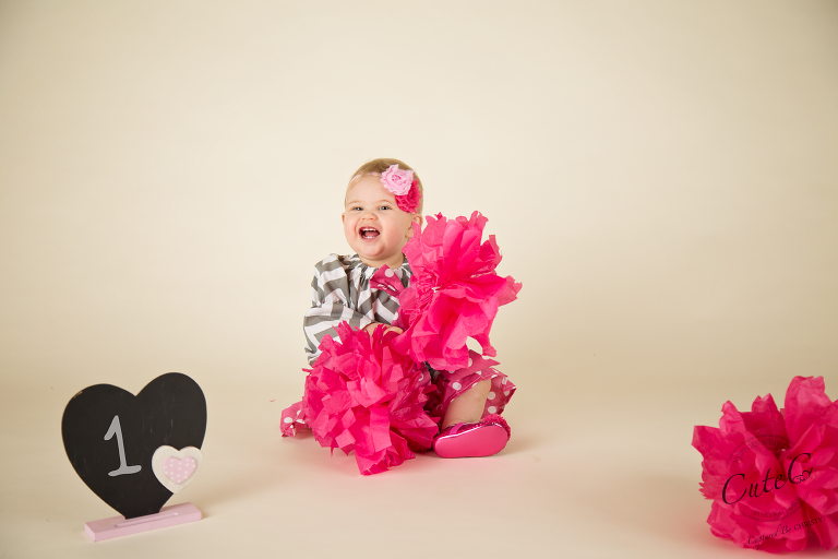 baby girl playing with pompoms