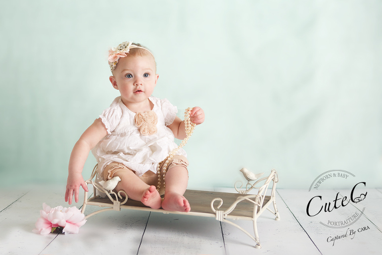 little girl on teal backdrop