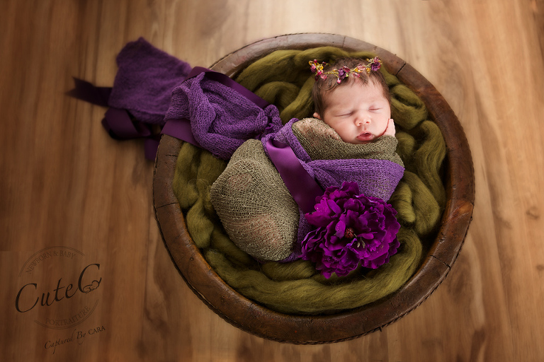 newborn in green and purple