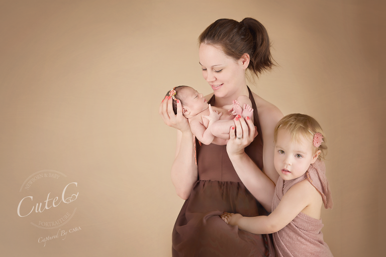 newborn with mom and sister